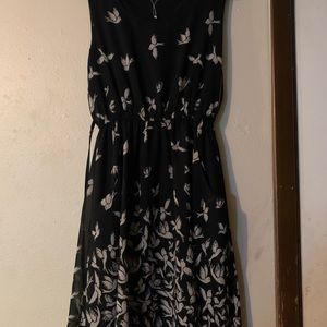Black short dress with birds on it has pockets